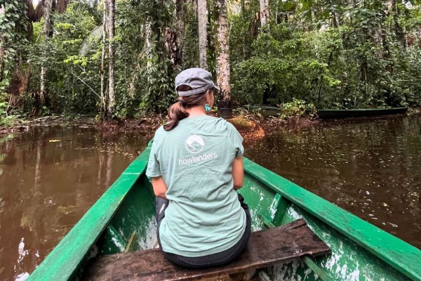 Kanufahrt durch den Amazonas-Regenwald Touristen paddeln auf einem von Vegetation umgebenen Fluss im Dschungel von Puerto Maldonado.