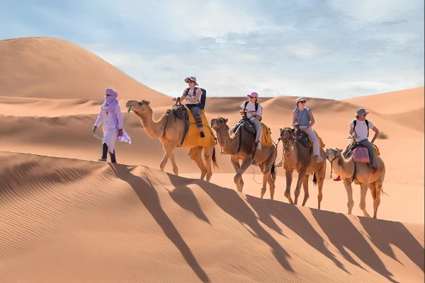 Camel Ride Through the Erg Chebbi Dunes Camel riders in the Erg Chebbi dunes during the tour from Marrakech to Fez