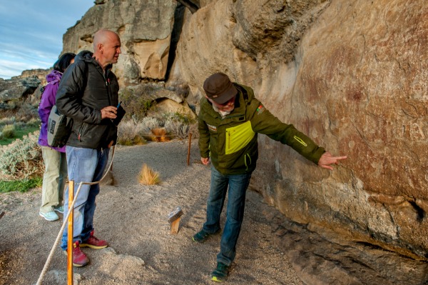 guide showing the cave paintings of the cave