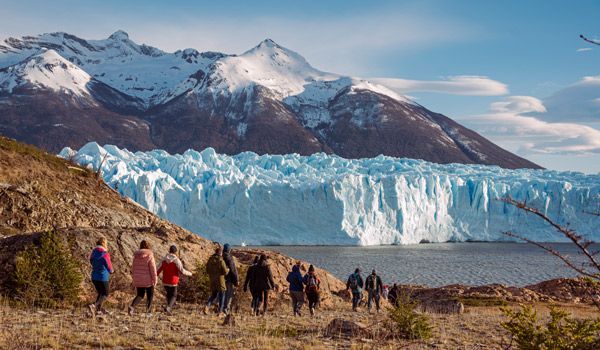 group walking with the Perito Moreno in front of them