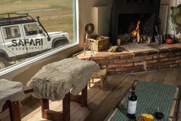 interior of the cabin in the safari experience with fireplace