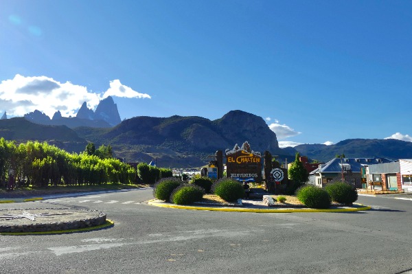 Entrance to the town of El Chaltén with traffic circle and mountains in the background.