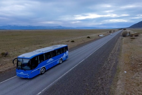 bus driving on the road between El Calafate and the airport