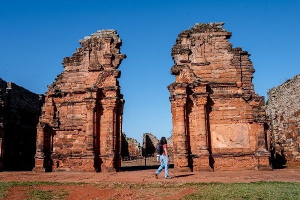 Traveler walking through the historic San Ignacio Miní Ruins