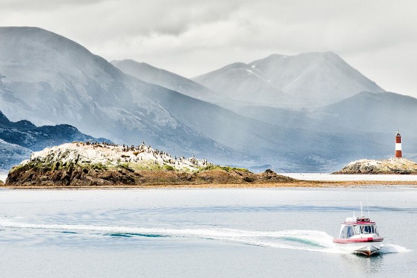 Speedboat on the Beagle Channel Speedboat cruising the Beagle Channel with the lighthouse in the background
