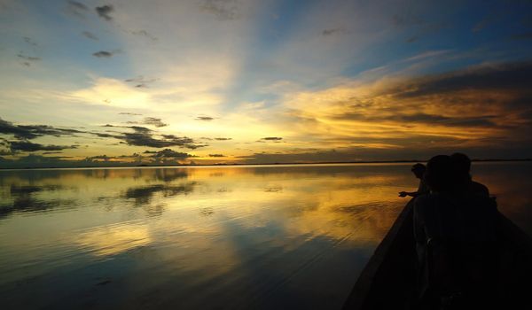 Sunrise in the jungle from a boat