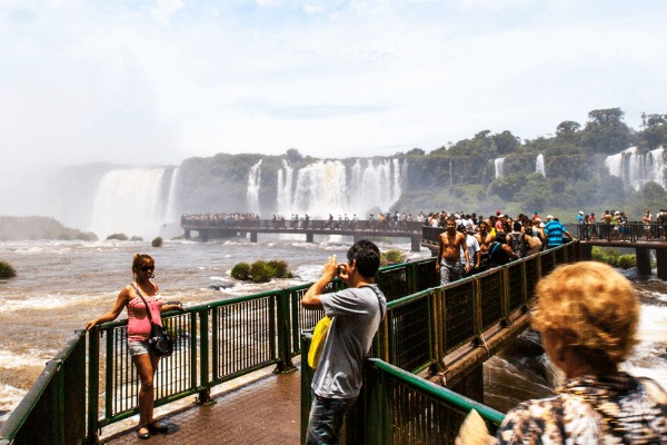 Travelers walk the Iguassu Falls trail in Brazil