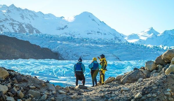 three people on the glacier moraine