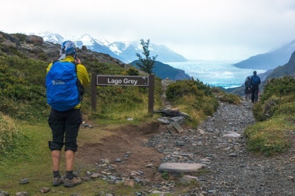 Grey lake path and hiker