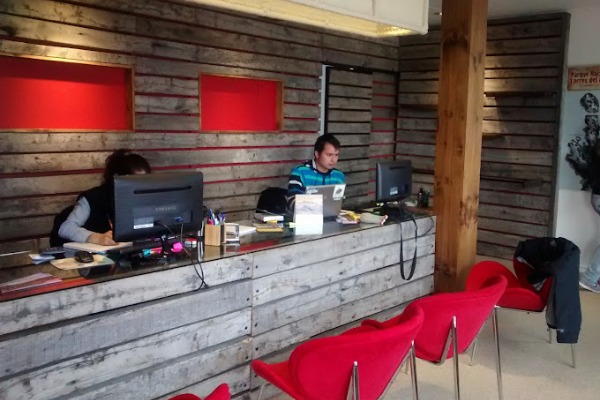 two people in front of a computer at the puerto natales office