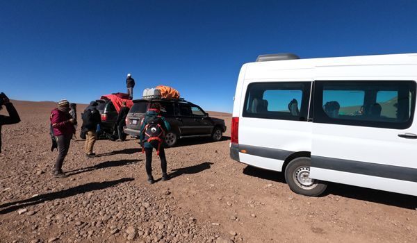 vans prepared for uyuni tour with backpacks
