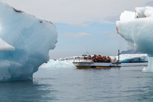 navigation between icebergs amphibious ship full of people in life jackets sailing among icebergs