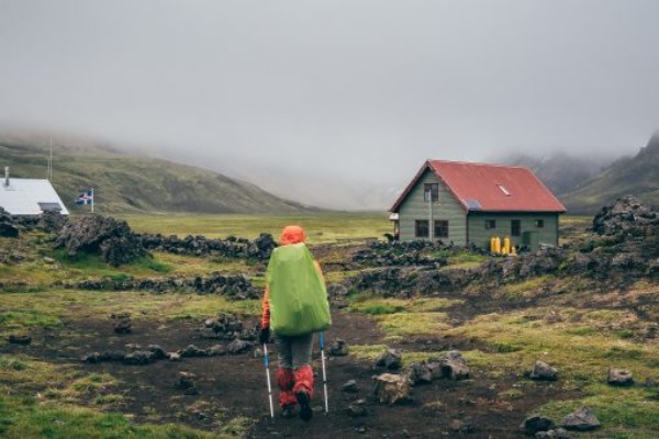 hiker on his back with backpack langidalur shelter