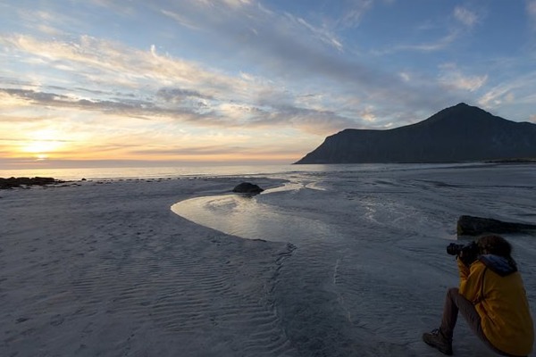 boy taking pictures in the midnight sun
