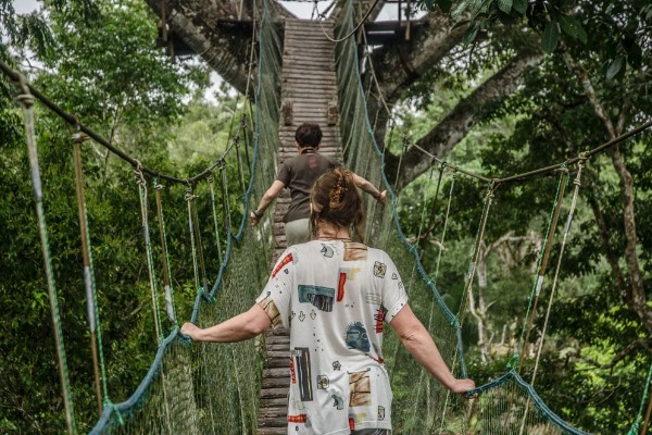 two people crossing the suspension bridge