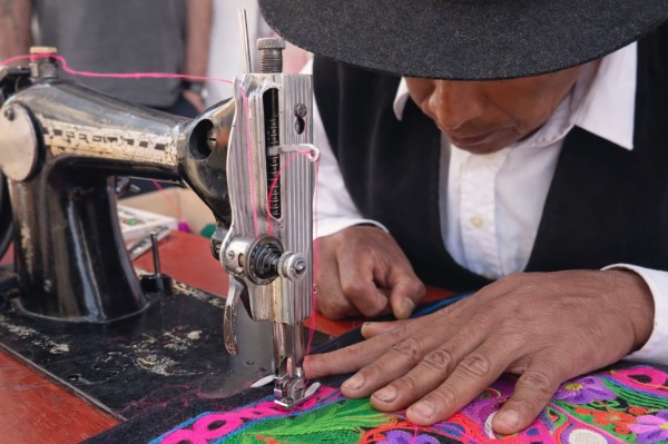 Man weaving with a machine