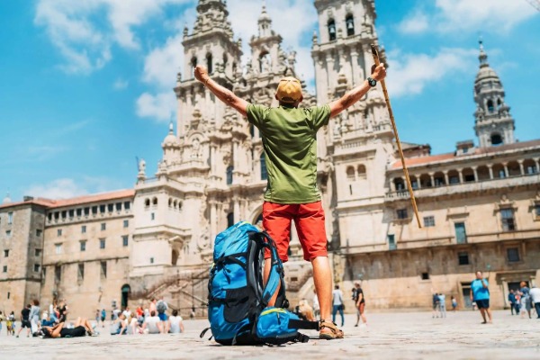 Arrival in Santiago de Compostela Pilgrim arriving at Santiago Cathedral after completing the Camino de Santiago from Tui