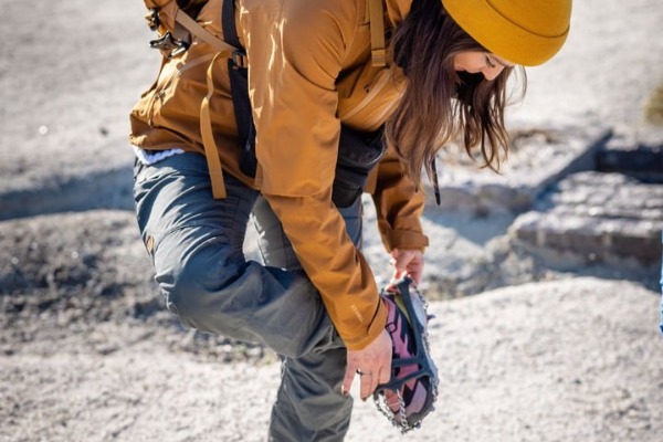chica colocandose los crampones chica con gorro colocandose los crampones