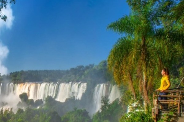 Donna su una passerella che ammira le Cascate dell'Iguazù dal lato brasiliano.