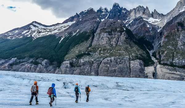 escursionisti che fanno la camminata sul ghiaccio sul ghiacciaio grigio